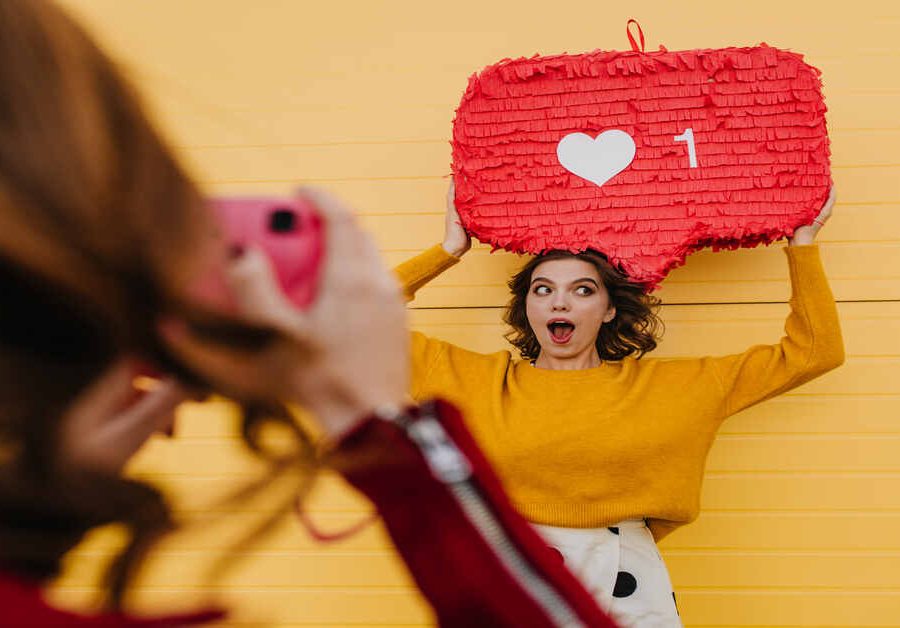 Selective focus of two girls having fun outdoor. Lovely woman in yellow sweater posing with heart i Want to Convert Followers? Storytelling Secrets?